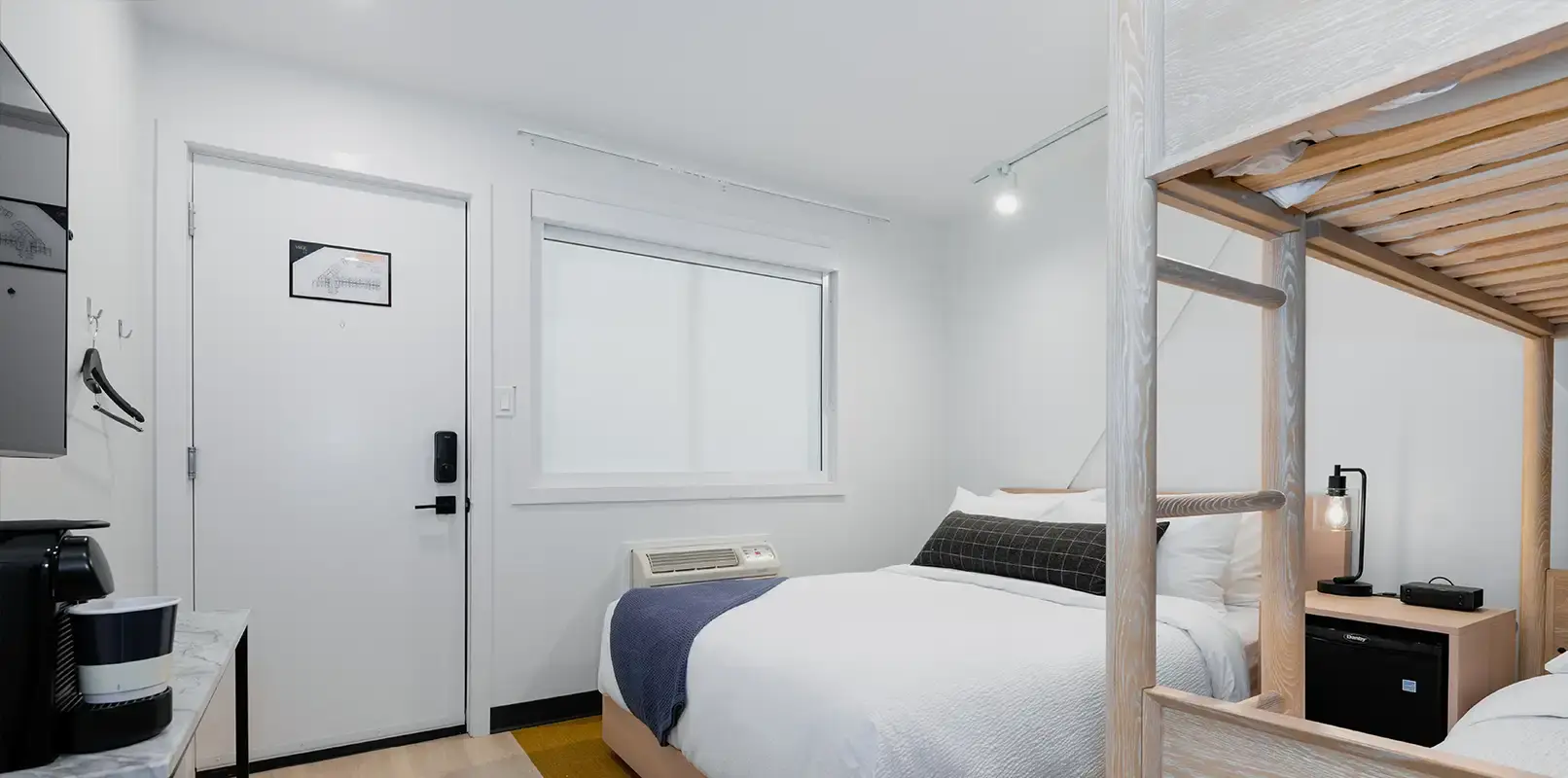 Alternative view of the Road Tripper Room at VRGE Hotel Revelstoke with queen bed and bunk bed – family-friendly hotel room in Revelstoke